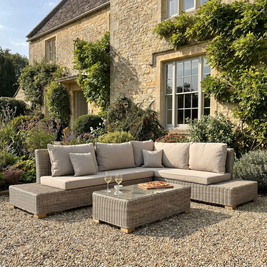 Capri outdoor corner sofa and coffee table set on a gravel patio